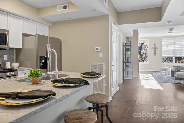 a kitchen with a refrigerator and a stove