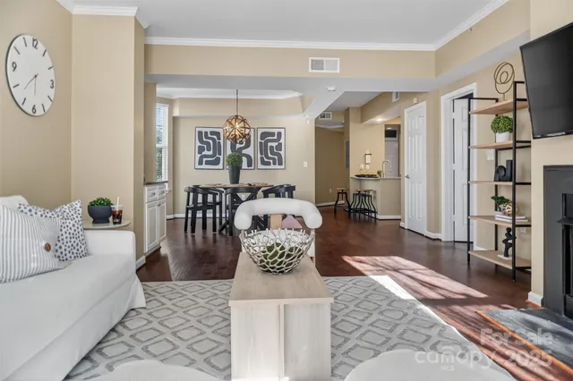 a living room with furniture wooden floor and a rug