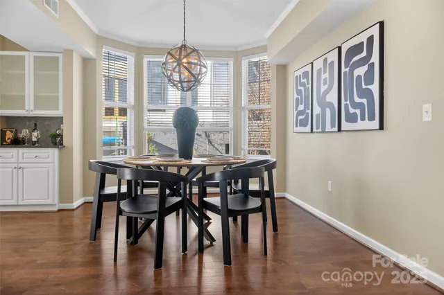 a view of a dining room with furniture wooden floor and chandelier