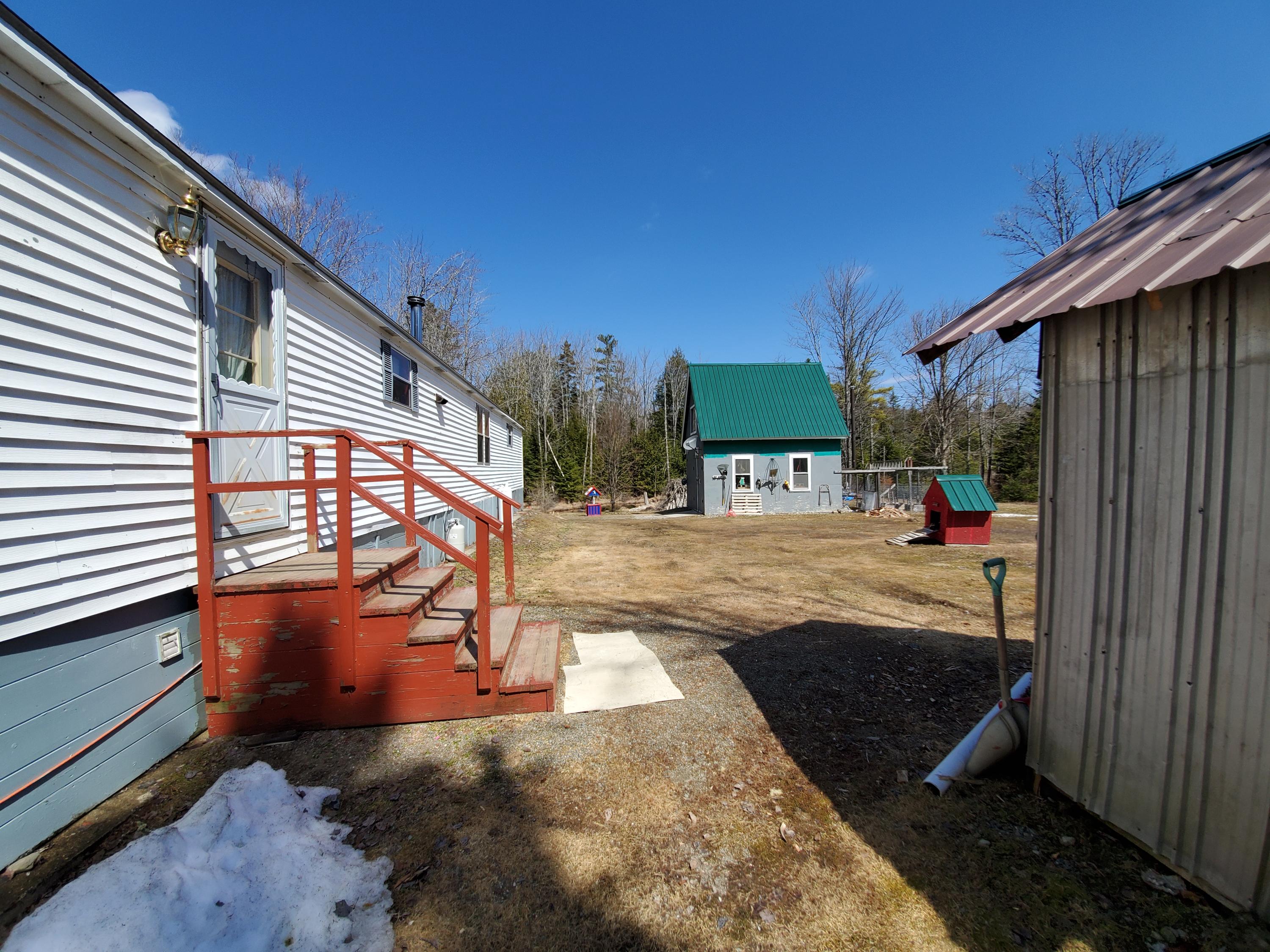 360 Half Township Road Lincoln, ME 04457 - Photo 36 of 36 Back yard + woodshed