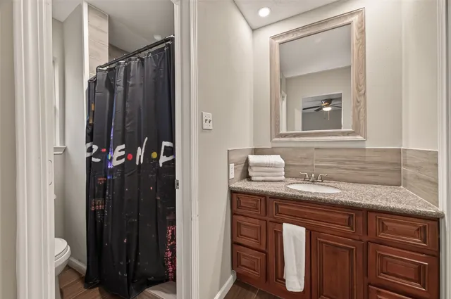 a bedroom with a bed and a ceiling fan