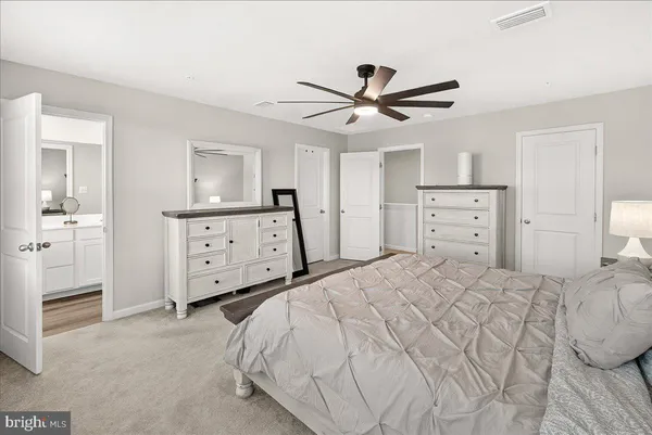 a bedroom with a bed and a dresser