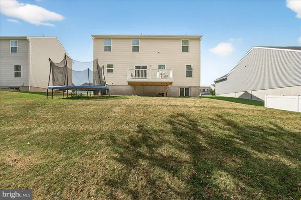 a view of an house with backyard space and balcony