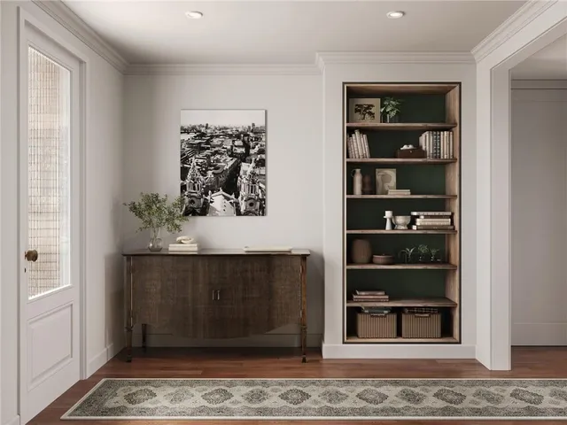a living room with painting on the wall and a window