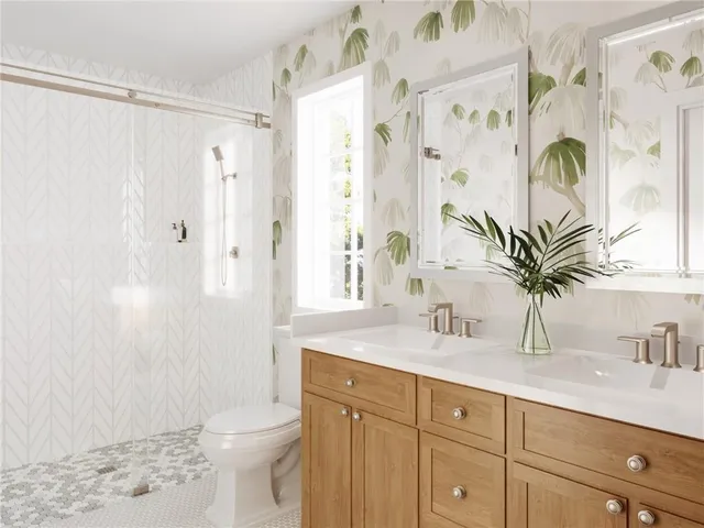 a bathroom with a granite countertop sink a toilet and a shower