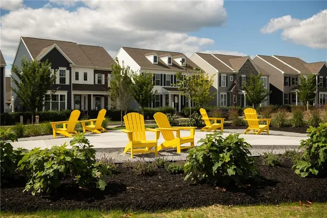 a view of a house with backyard water fountain and sitting area