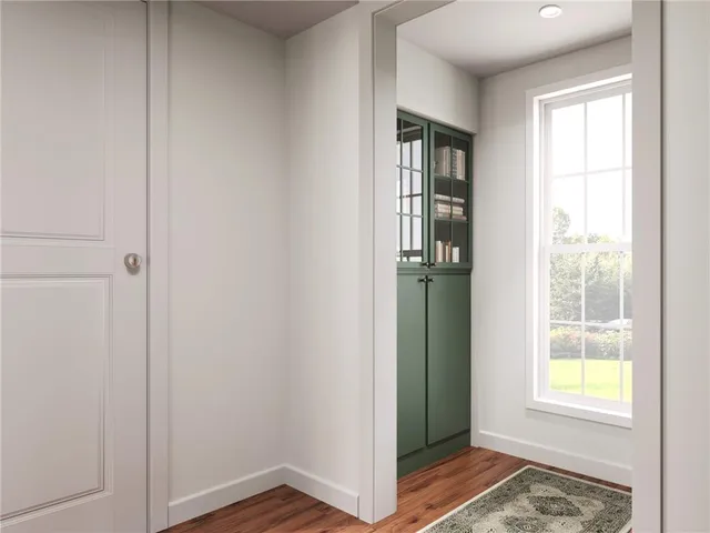 an empty room with windows and closet