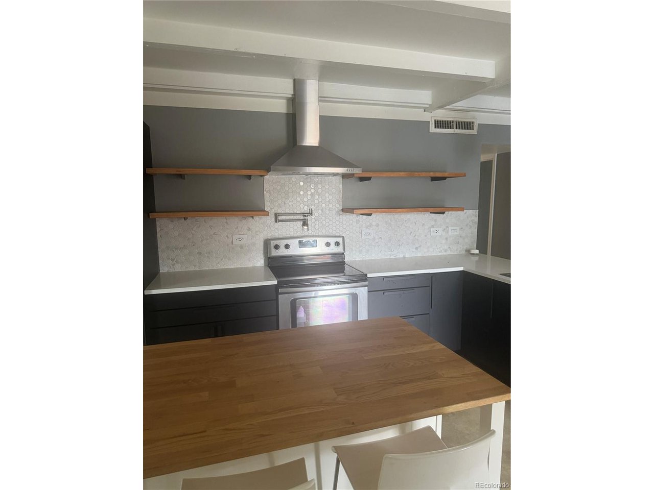 1040 Stuart Street Denver, CO 80204 - Photo 20 of 30 a kitchen with a stove and a refrigerator