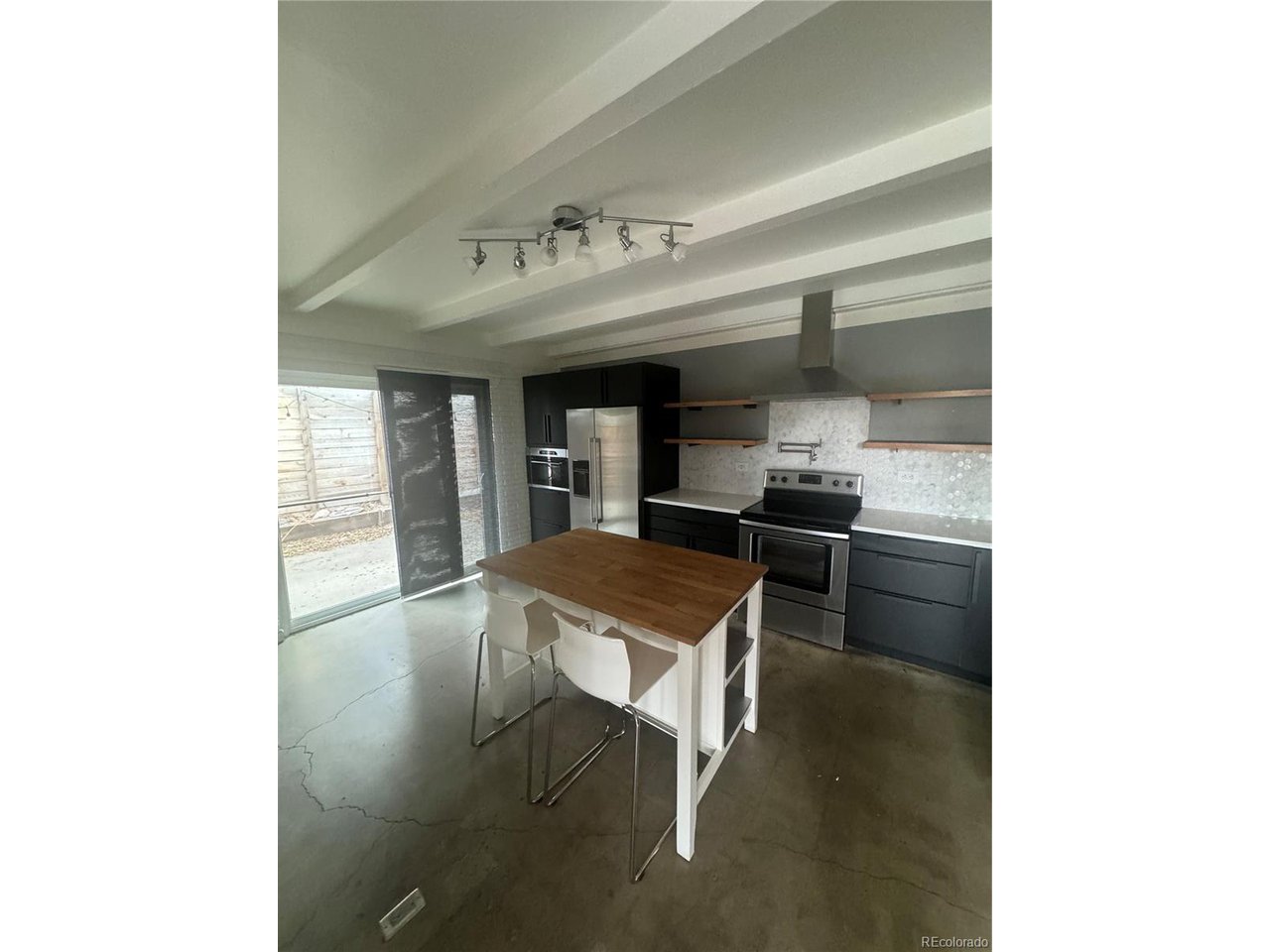 1040 Stuart Street Denver, CO 80204 - Photo 21 of 30 a kitchen with a sink cabinets and counter space