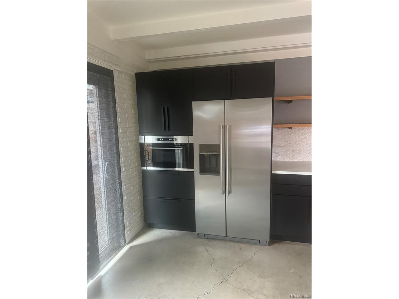 1040 Stuart Street Denver, CO 80204 - Photo 22 of 30 a kitchen with cabinets and stainless steel appliances
