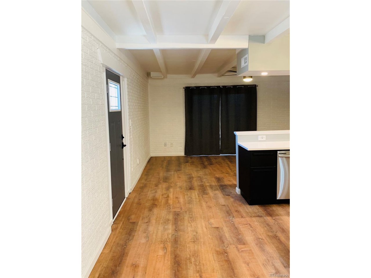 1040 Stuart Street Denver, CO 80204 - Photo 5 of 30 a view of a hallway with wooden floor