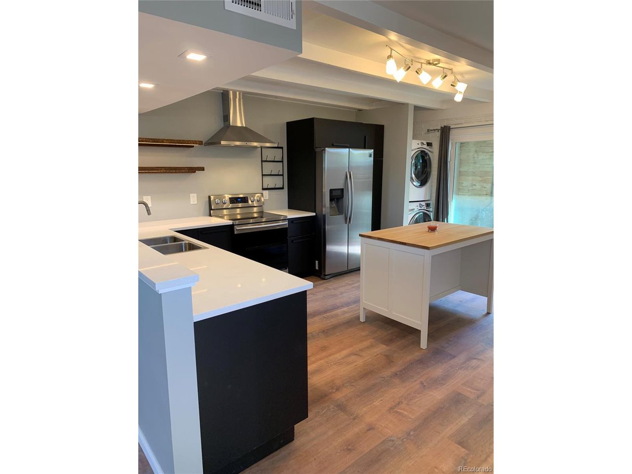 1040 Stuart Street Denver, CO 80204 - Photo 6 of 30 a kitchen with a sink and cabinets