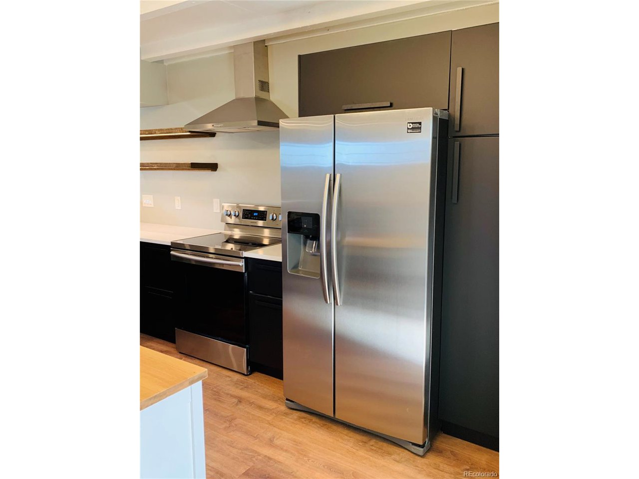 1040 Stuart Street Denver, CO 80204 - Photo 7 of 30 a kitchen with a refrigerator and a refrigerator