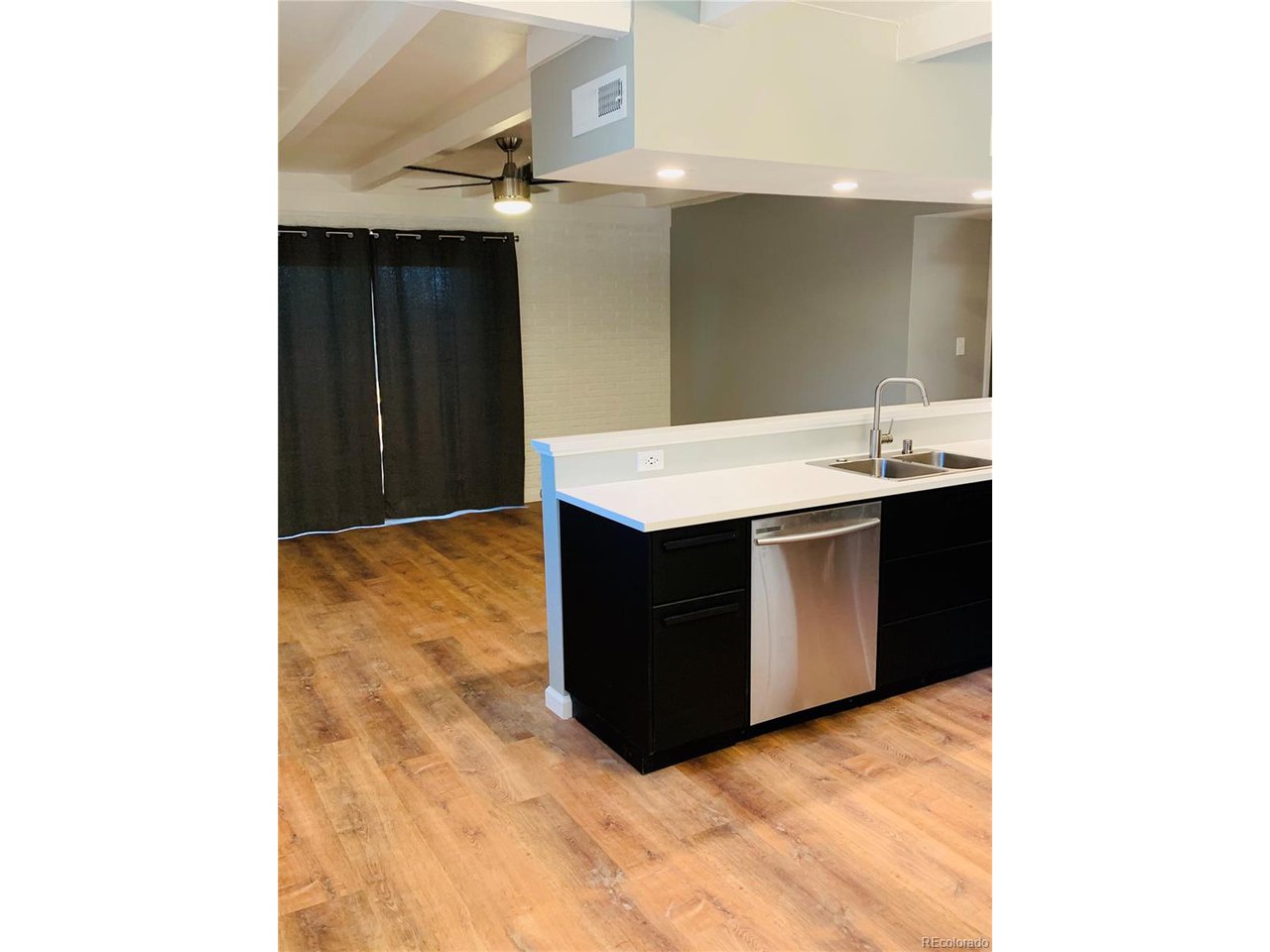1040 Stuart Street Denver, CO 80204 - Photo 8 of 30 a kitchen with a sink and a mirror