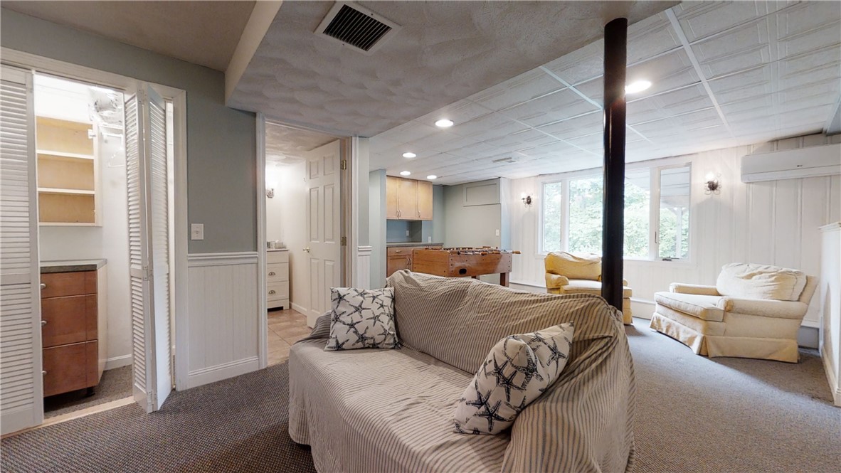 87 Treasure Road Narragansett, RI 02882 - Photo 13 of 21 The nicely finished garden level has a big picture window to let in lots of natural light and access to outside