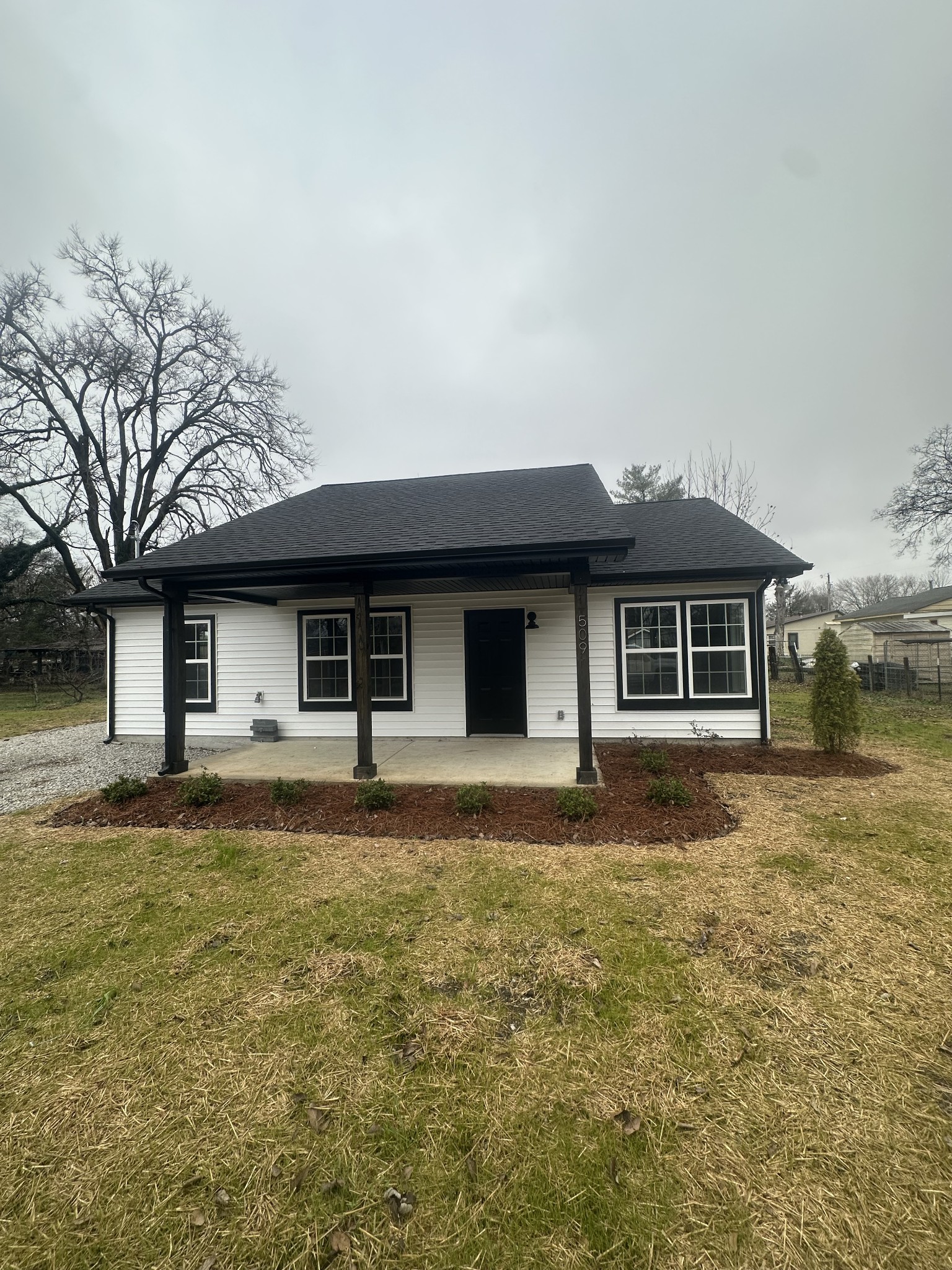 a front view of a house with a garden