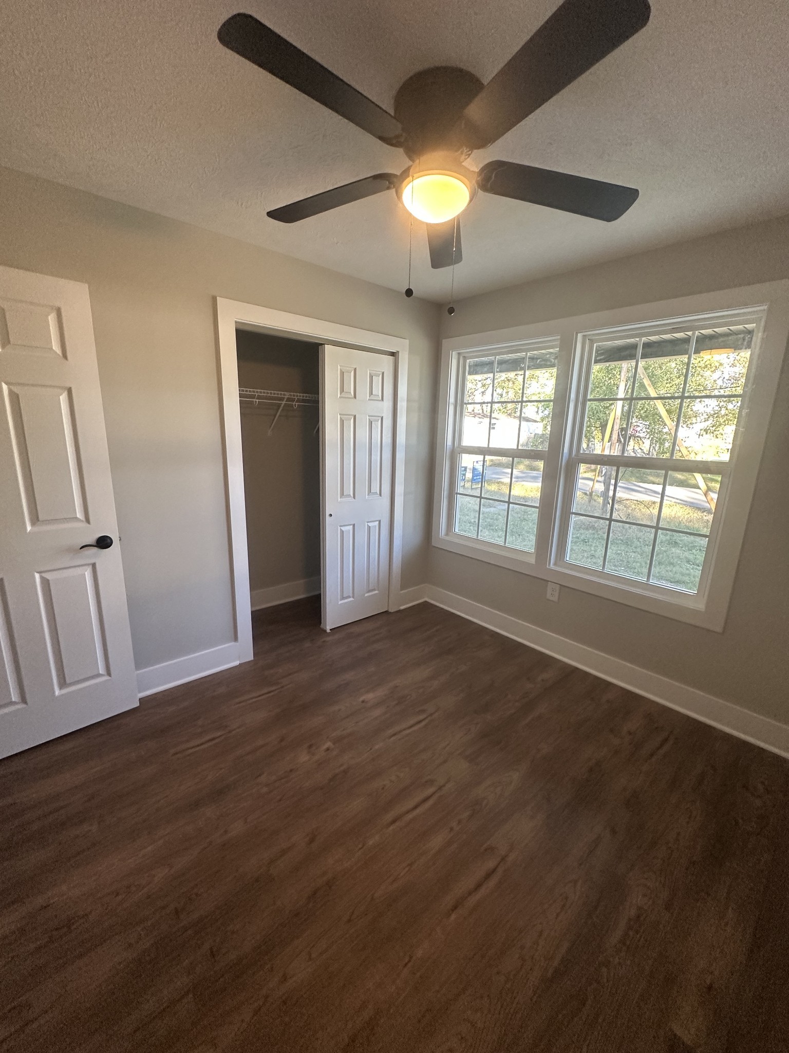 509 Brakefield Street Cowan, TN 37318 - Photo 14 of 19 an empty room with wooden floor and windows