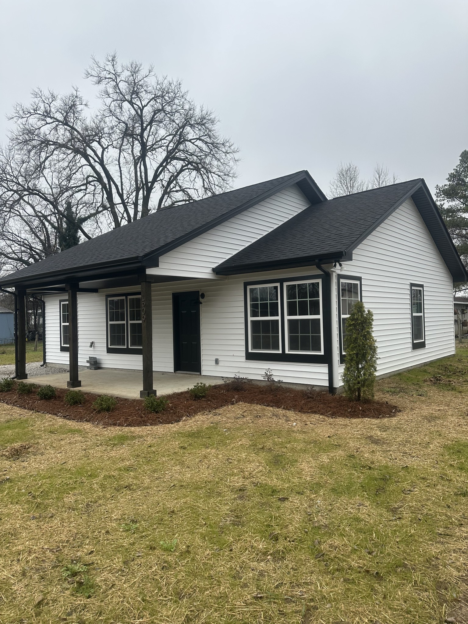 509 Brakefield Street Cowan, TN 37318 - Photo 2 of 19 a front view of a house with a garden and yard