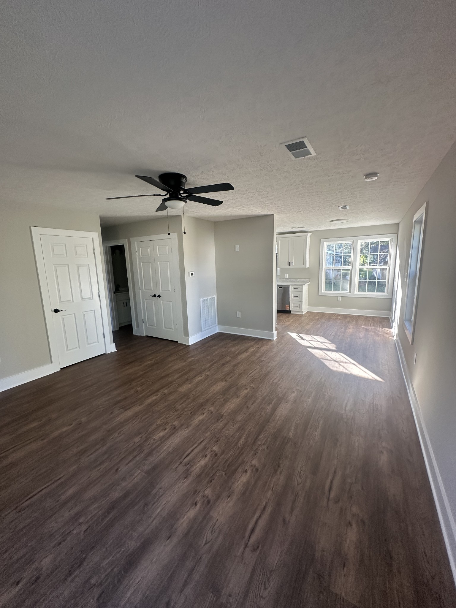 509 Brakefield Street Cowan, TN 37318 - Photo 7 of 19 a view of empty room with wooden floor and fan