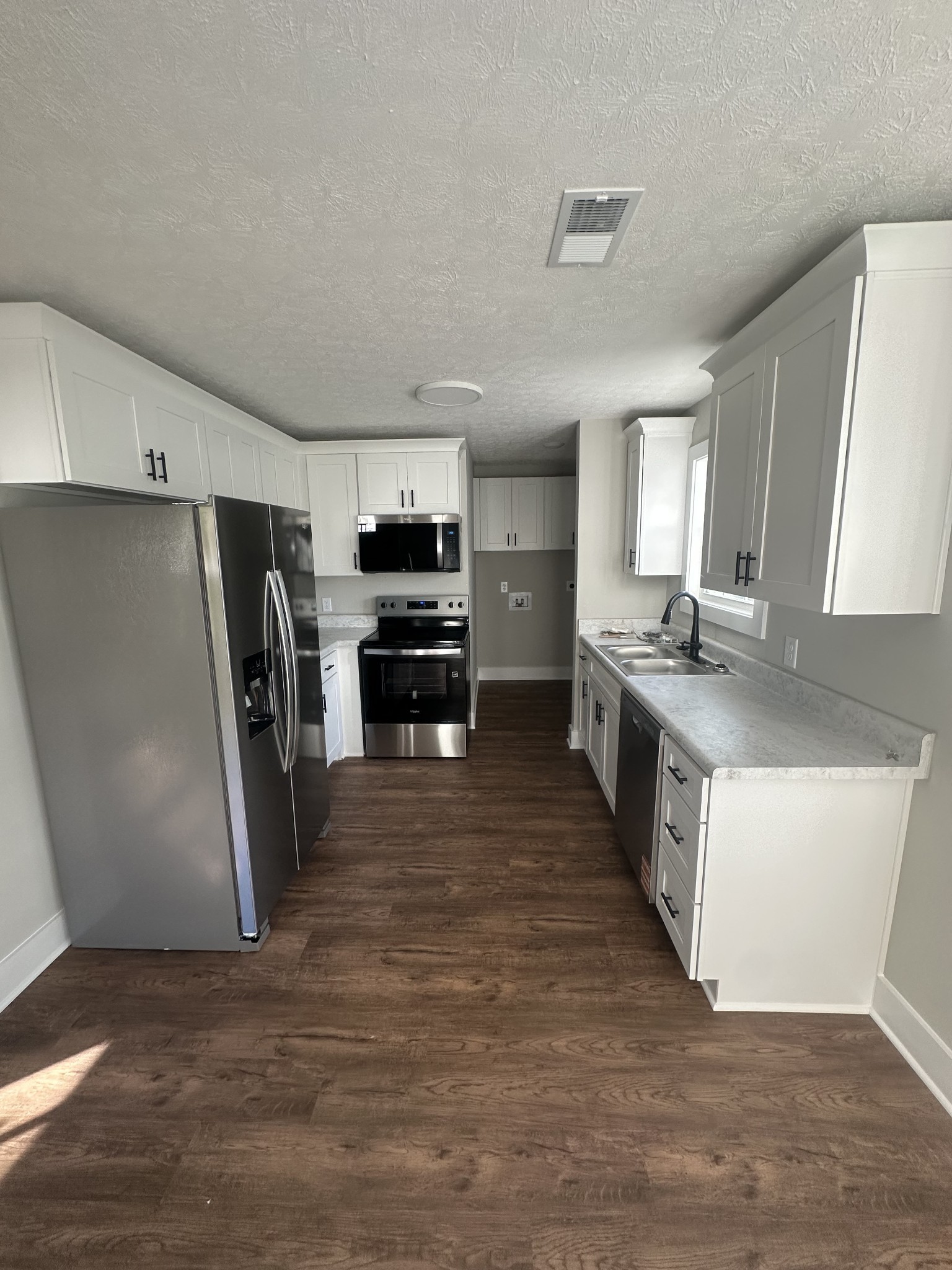 509 Brakefield Street Cowan, TN 37318 - Photo 8 of 19 a view of kitchen with refrigerator stove microwave and sink