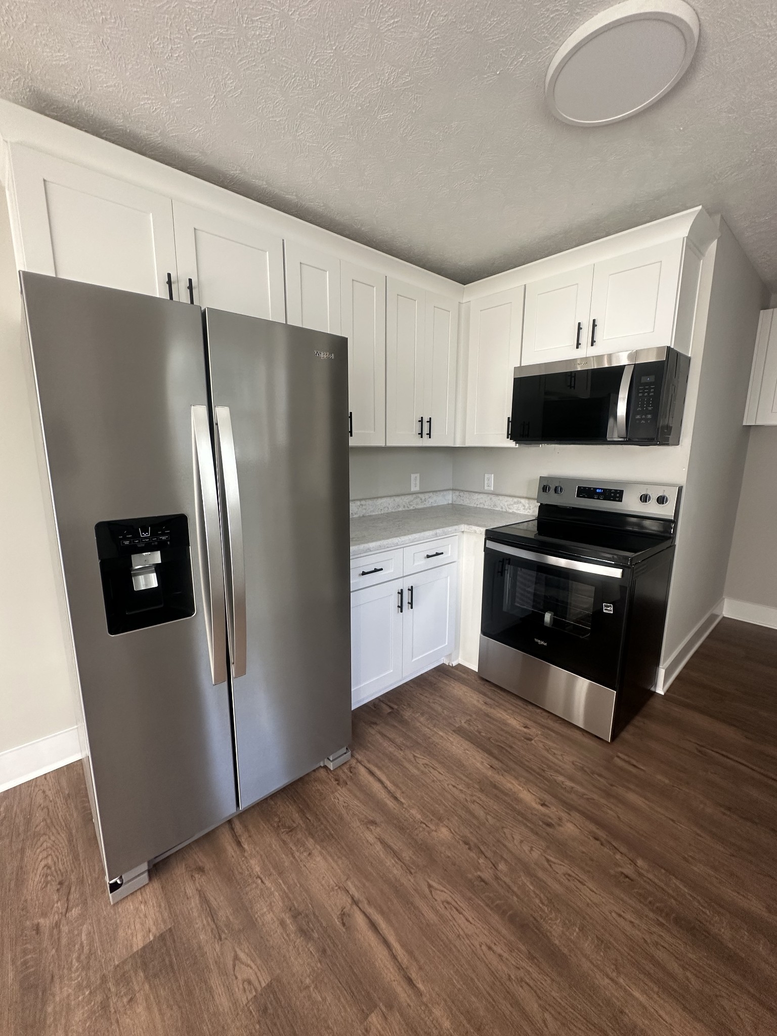 509 Brakefield Street Cowan, TN 37318 - Photo 10 of 19 a kitchen with stainless steel appliances a refrigerator sink and microwave