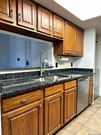 a kitchen with stainless steel appliances granite countertop a sink and cabinets