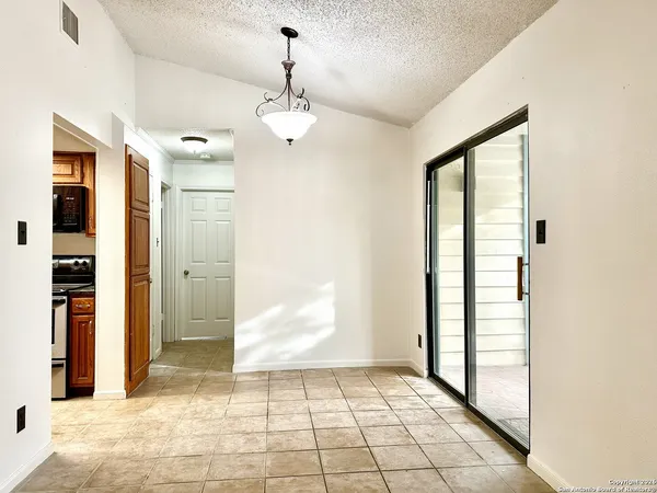 a view of a hallway with a chandelier