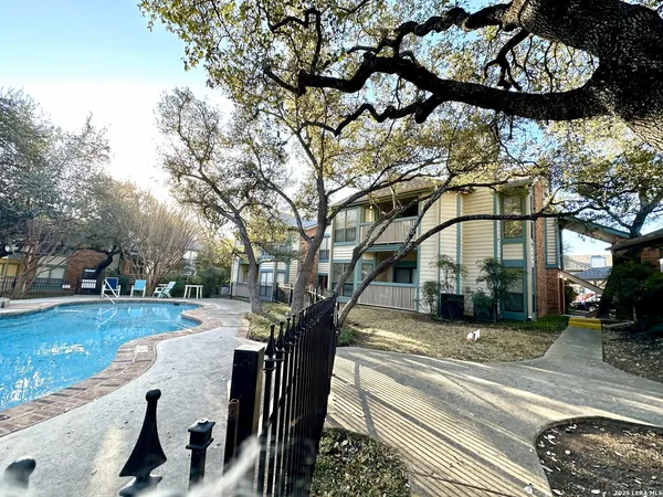 a view of a swimming pool with an outdoor space and seating area