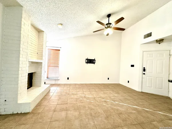 a view of empty room with a fireplace