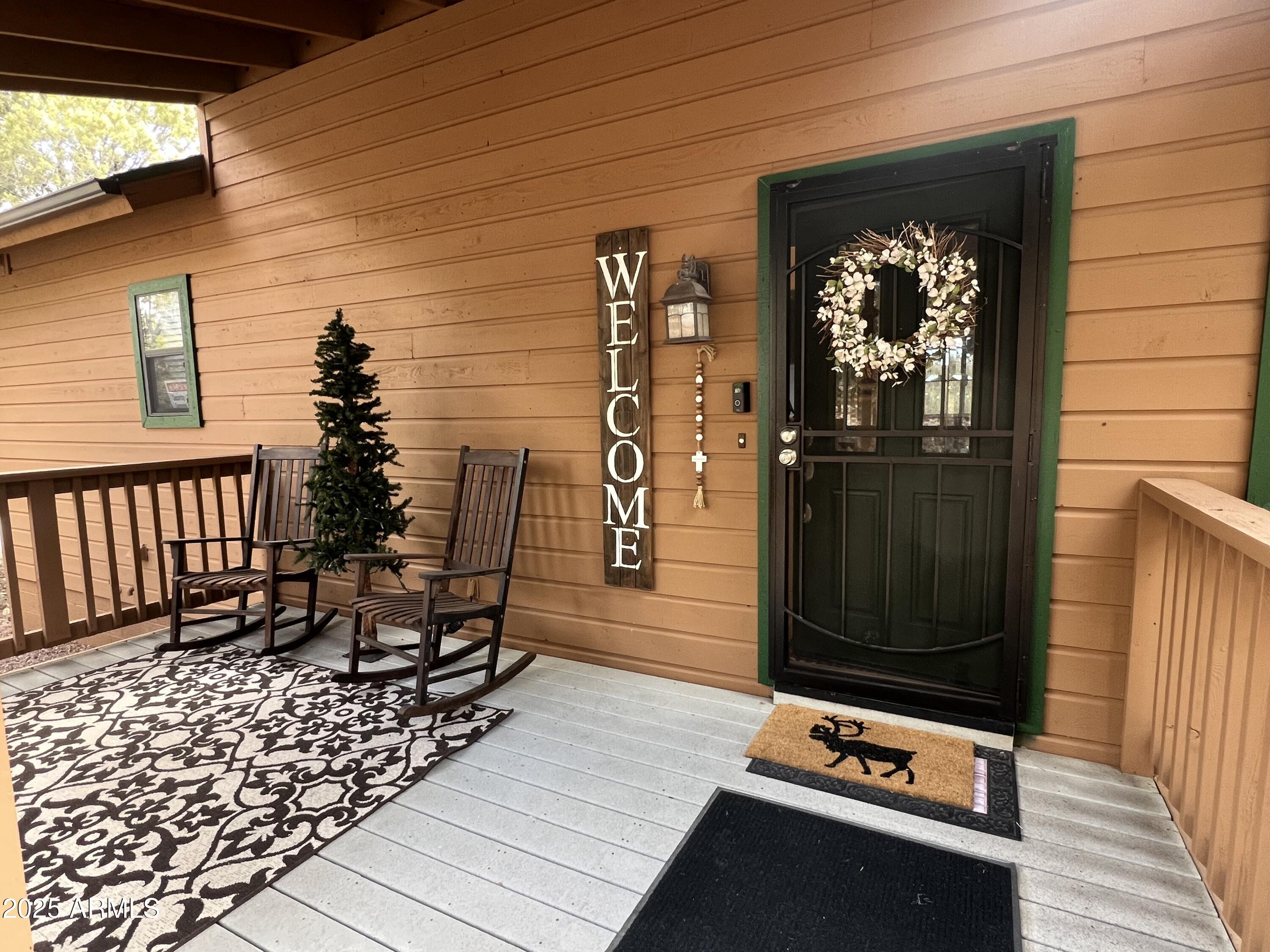 a view of a porch with a table and chairs