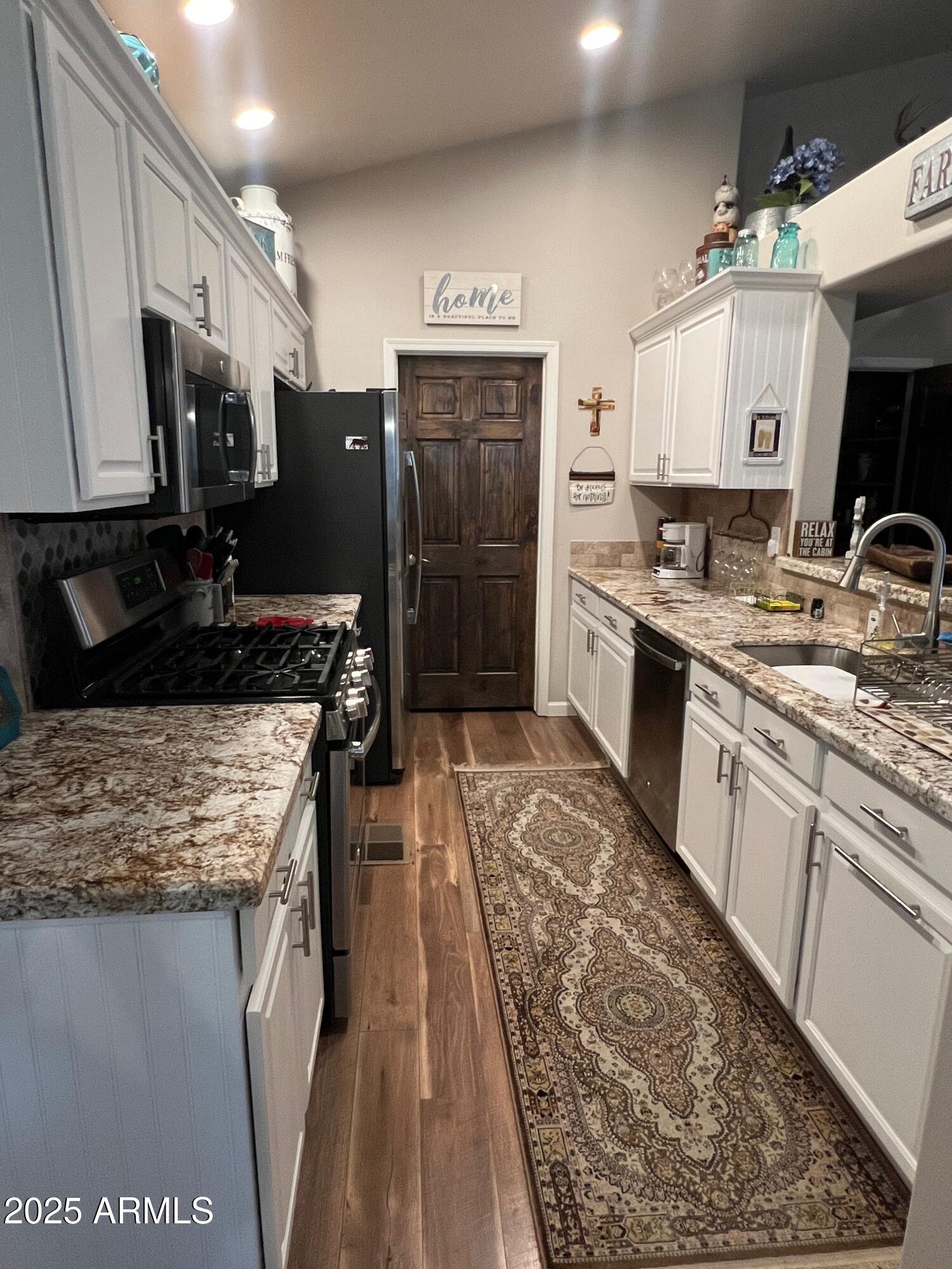 3473 High Country Drive Heber, AZ 85928 - Photo 4 of 38 a large kitchen with stainless steel appliances kitchen island granite countertop a sink stove and refrigerator