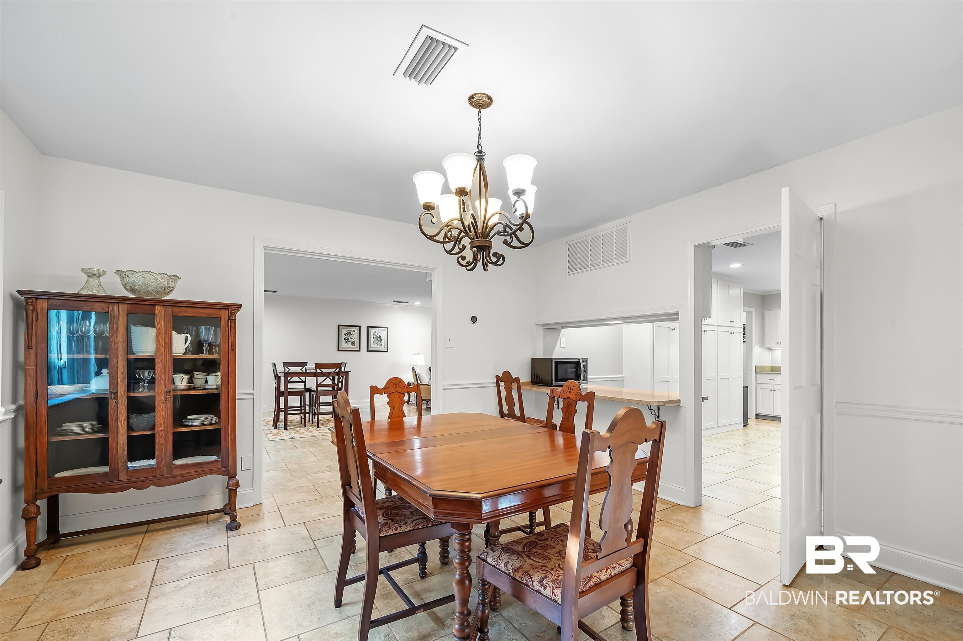 104 James Circle Daphne, AL 36526 - Photo 34 of 62 Tiled dining room featuring an inviting chandelier