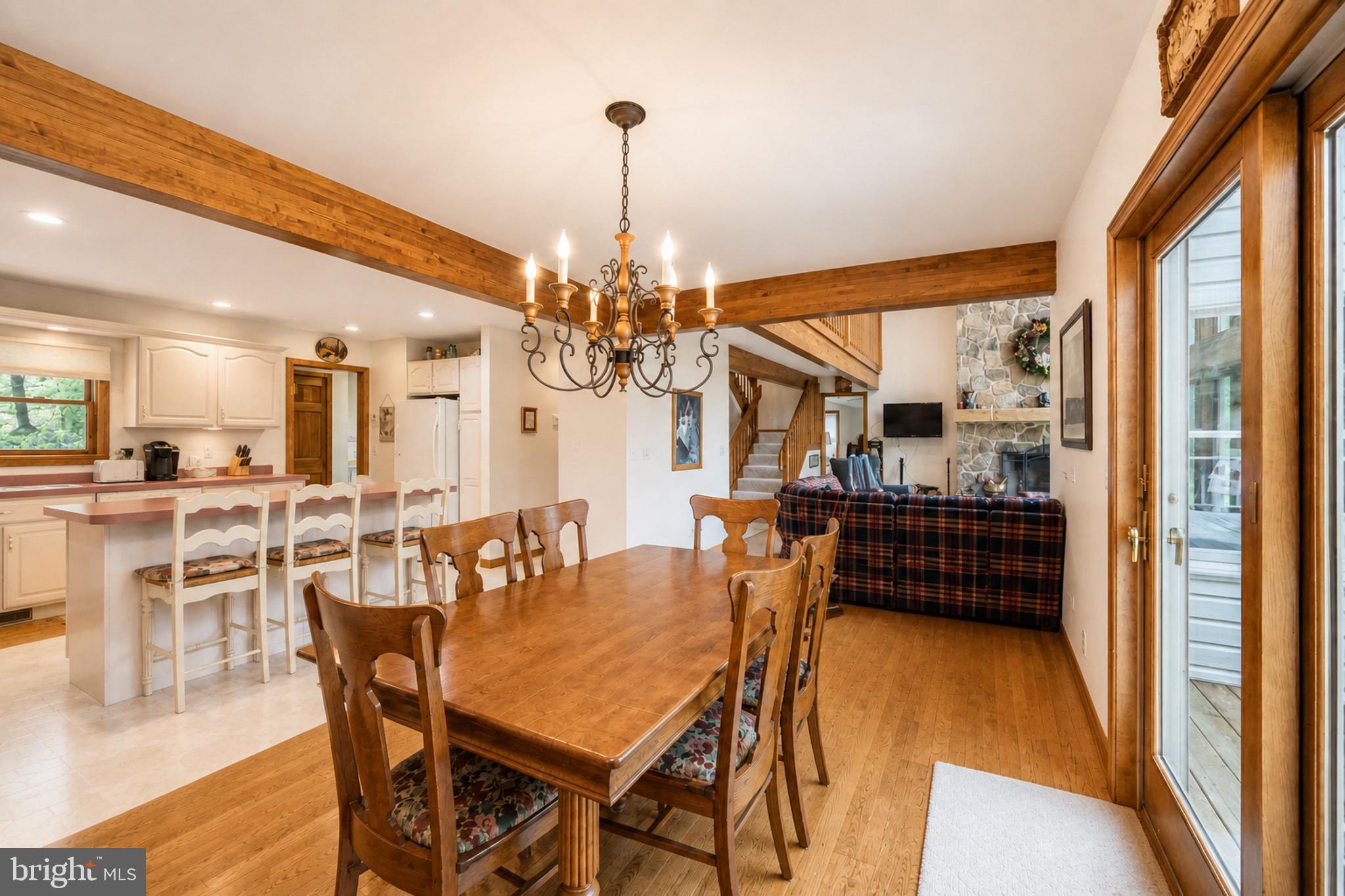 389 Sawmill Hollow Road Swanton, MD 21561 - Photo 10 of 62 a dining room with furniture a chandelier and wooden floor