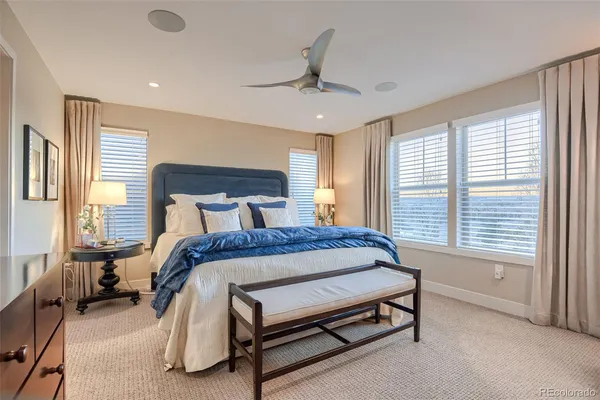 a living room with a couch a window and a clock