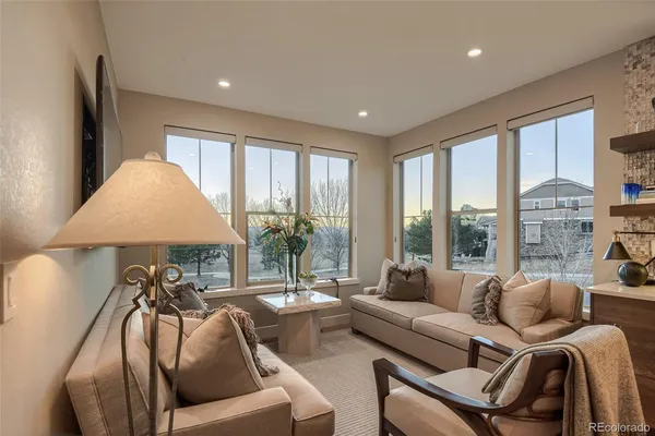 a kitchen with stainless steel appliances a dining table chairs and wooden floor