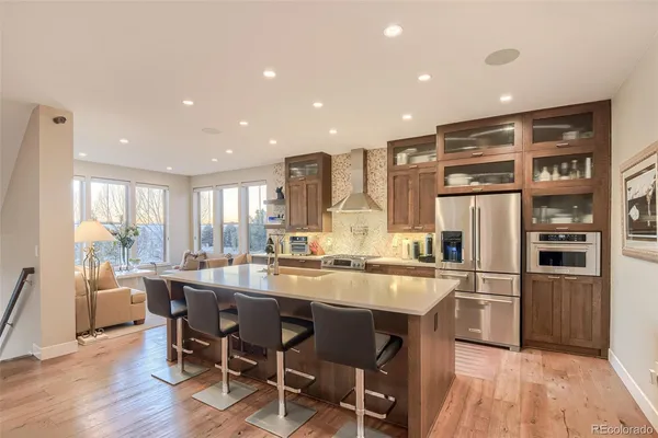 a kitchen with stainless steel appliances a sink stove and cabinets