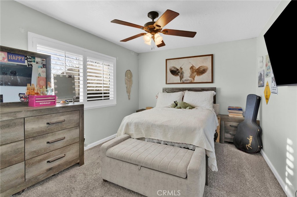 21940 Carlisle Road Apple Valley, CA 92307 - Photo 14 of 32 a bedroom with a bed and a flat screen tv