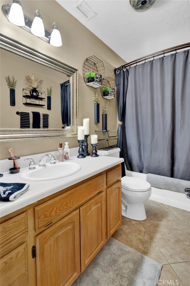 21940 Carlisle Road Apple Valley, CA 92307 - Photo 19 of 32 a bathroom with a sink a toilet and mirror