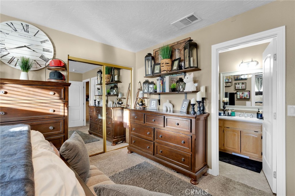 21940 Carlisle Road Apple Valley, CA 92307 - Photo 22 of 32 a kitchen with stainless steel appliances granite countertop a stove and cabinets