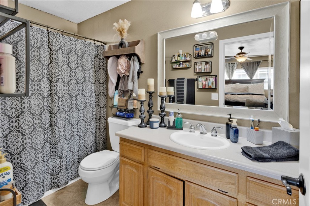 21940 Carlisle Road Apple Valley, CA 92307 - Photo 23 of 32 a bathroom with a sink vanity mirror and toilet