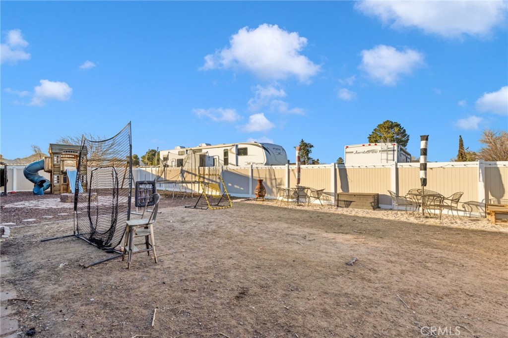 21940 Carlisle Road Apple Valley, CA 92307 - Photo 26 of 32 a view of a terrace with a table and chairs