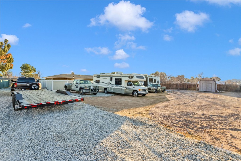 21940 Carlisle Road Apple Valley, CA 92307 - Photo 30 of 32 a car parked on the side of the road