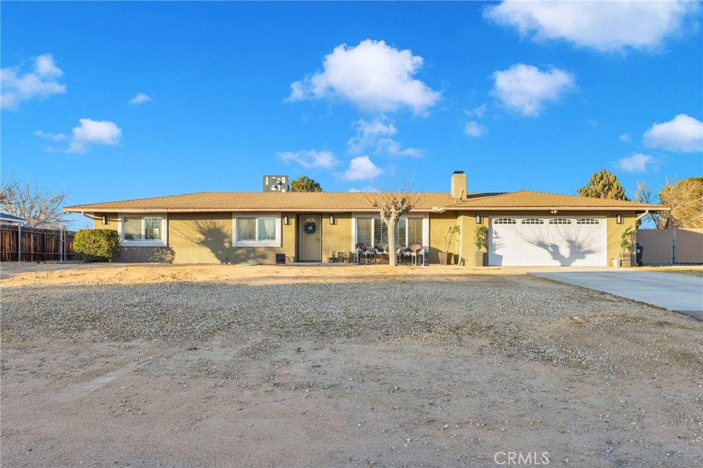 21940 Carlisle Road Apple Valley, CA 92307 - Photo 4 of 32 a view of a house with a yard and garage