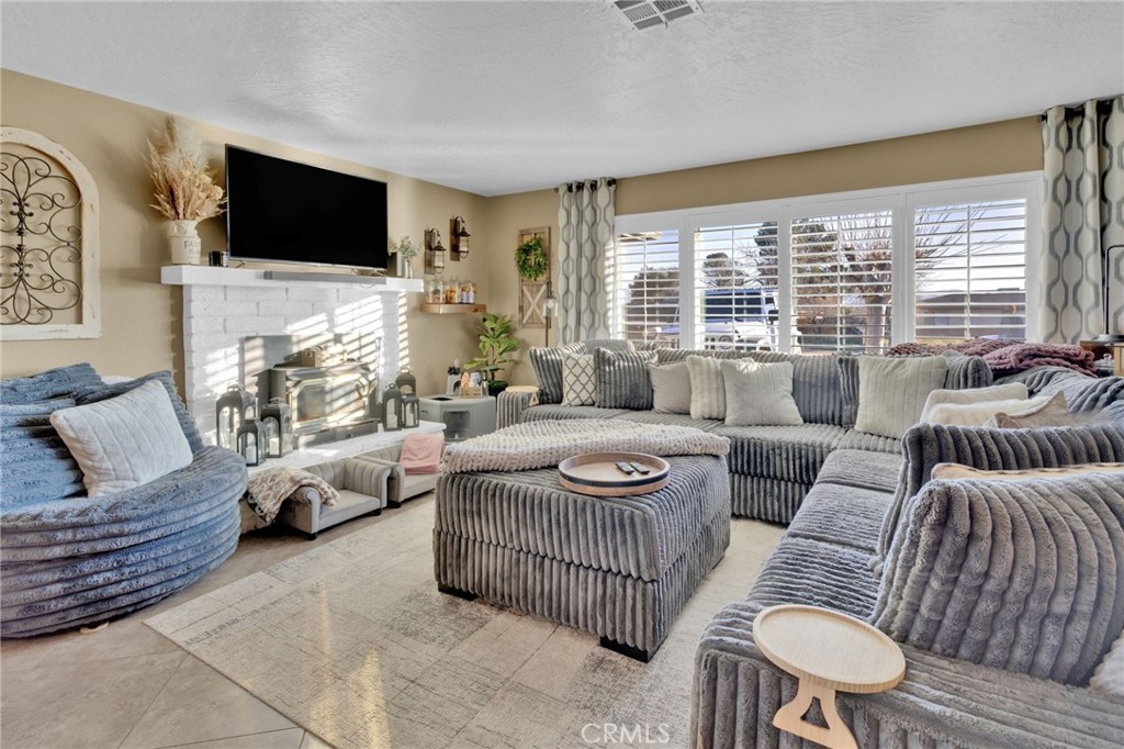 21940 Carlisle Road Apple Valley, CA 92307 - Photo 6 of 32 a living room with furniture and a flat screen tv