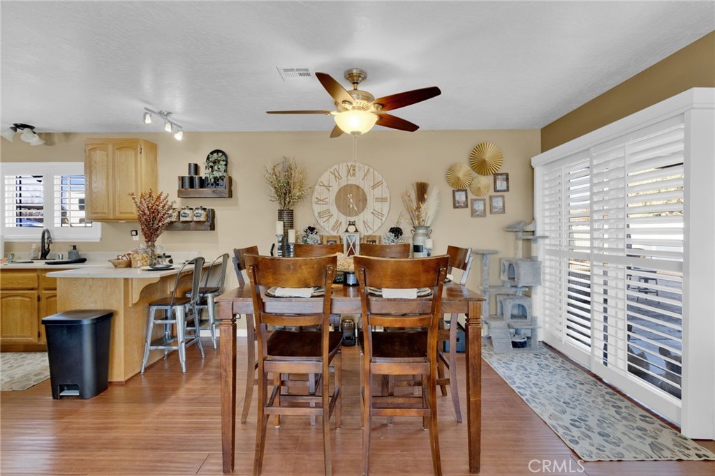 21940 Carlisle Road Apple Valley, CA 92307 - Photo 10 of 32 a view of a dining room with furniture and wooden floor