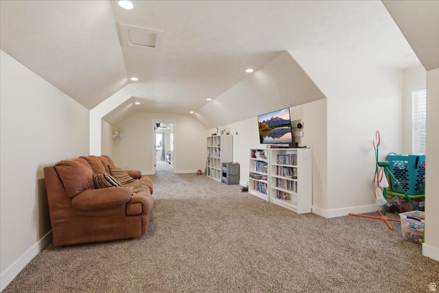 1232 Canyon Road Tooele, UT 84074 - Photo 34 of 54 Spacious bonus room featuring vaulted ceilings, recessed lighting, neutral carpeting, and a doorway opening to another room
