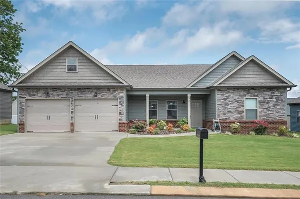 a front view of a house with a yard and garage