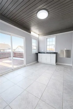 a large white kitchen with a large window