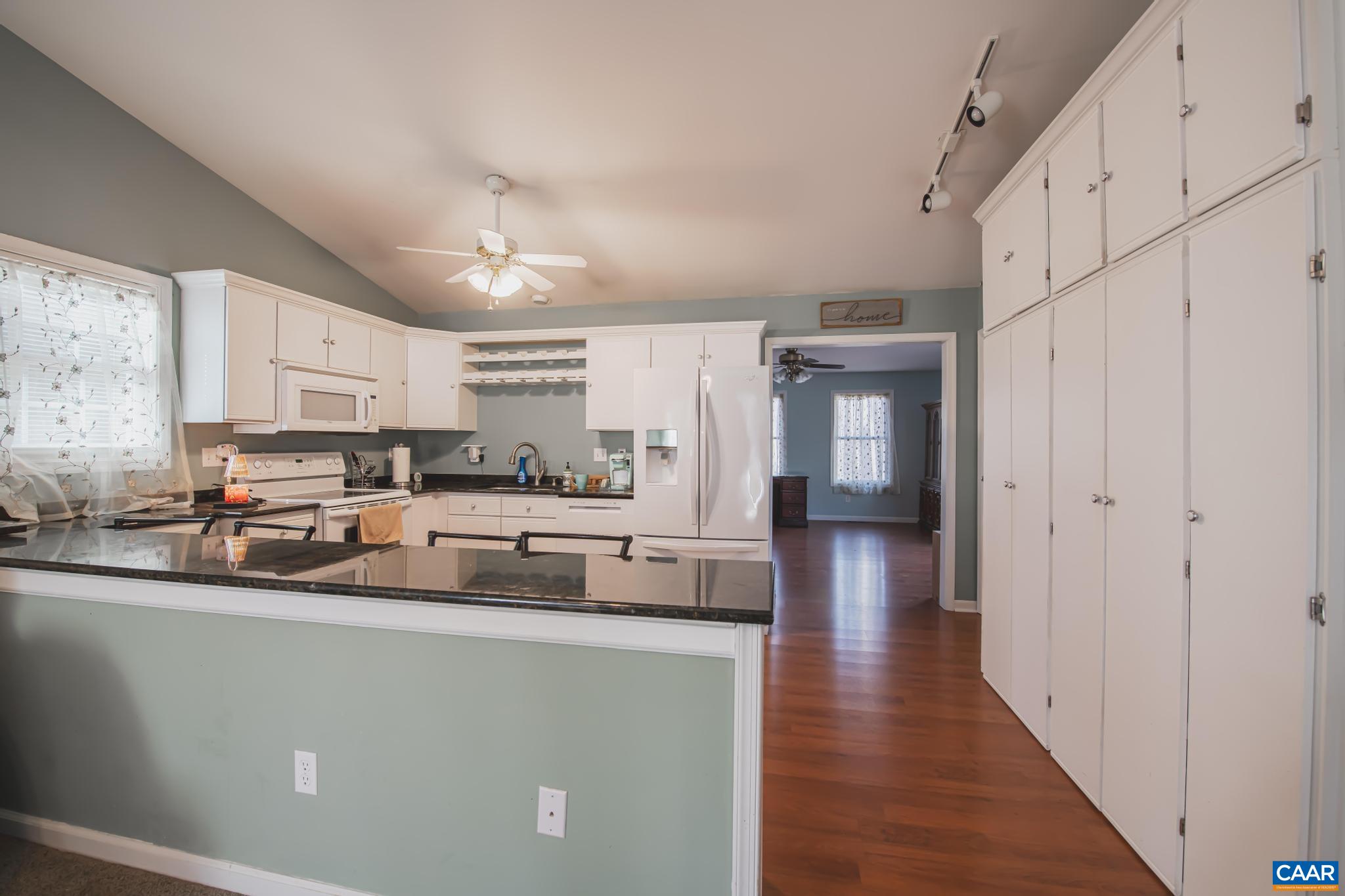 18 Cliftwood Road Palmyra, VA 22963 - Photo 3 of 28 a kitchen with stainless steel appliances granite countertop a refrigerator a sink dishwasher a stove and white countertops with wooden floor