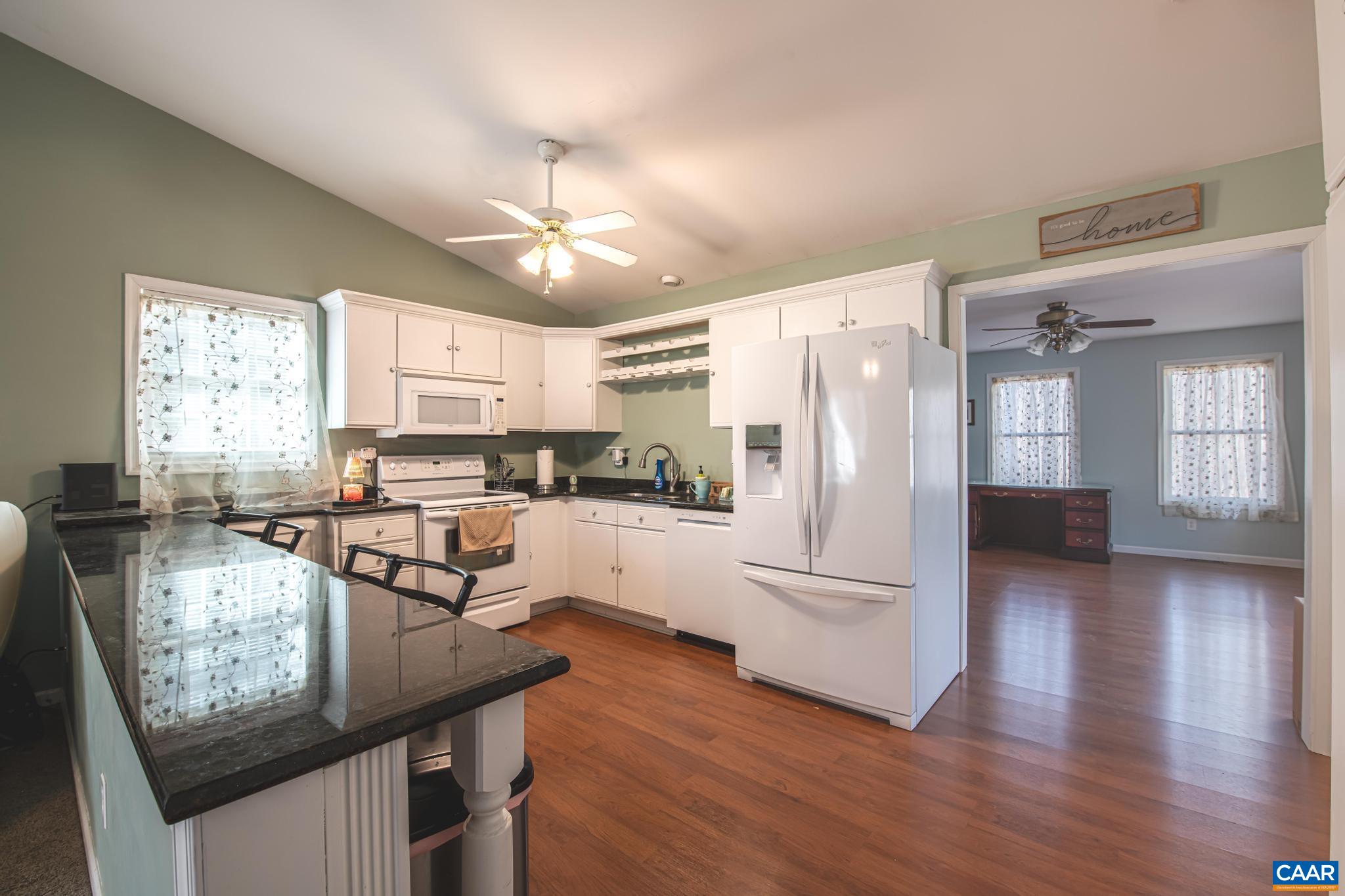 18 Cliftwood Road Palmyra, VA 22963 - Photo 5 of 28 a kitchen with stainless steel appliances granite countertop a refrigerator a stove a sink dishwasher a stove and white countertops with wooden floor